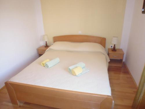 a bedroom with a bed with two boxes on it at Villa Malisko in Hvar