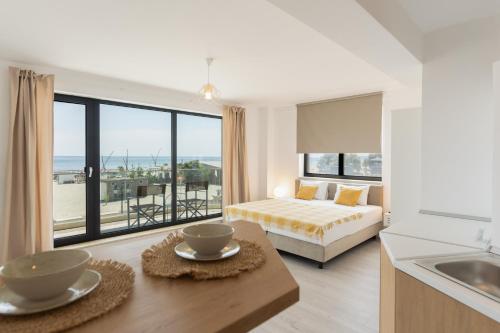 a bedroom with a bed and a view of the ocean at Milena in Mamaia Sat/Năvodari