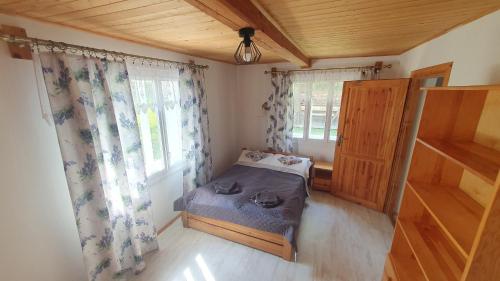 a small bedroom with a bed and a window at Wierzchowina Relax & Reset in Łęki Dolne