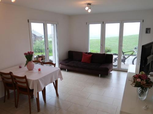 a living room with a table and a couch at Apartment Luxenweid by Interhome in Reichenburg