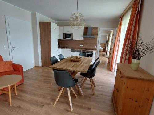 a kitchen and dining room with a wooden table and chairs at Apartment Lilie by Interhome in Velden am Wörthersee