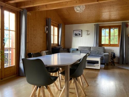 a dining room with a table and chairs at Chalet Chalet 1627 by Interhome in Moleson