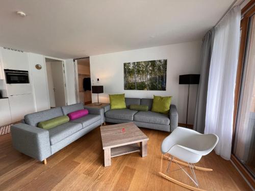 a living room with a couch and a table at Apartment Residence Bellevue by Interhome in Zell am See