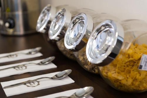a group of silver spoons and forks on a table at Bürgerhofhotel in Cologne