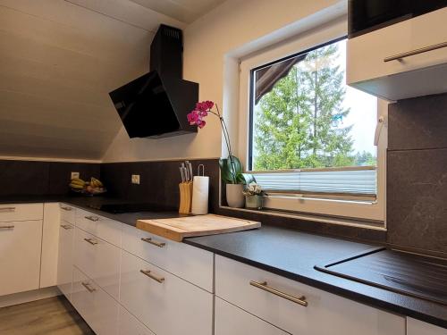 a kitchen with white cabinets and a window and a counter at Apartment Lercher by Interhome in Seefeld in Tirol