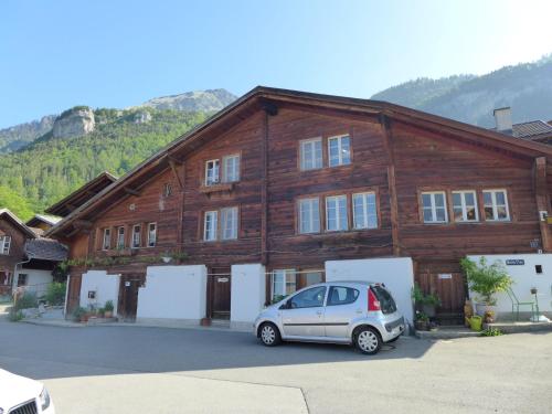 a car parked in front of a wooden building at Apartment Beim Thor by Interhome in Brienzwiler