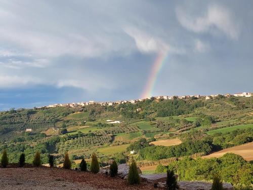 a rainbow in the sky over a valley at Gemelli in Petacciato