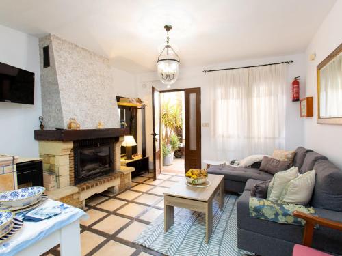 a living room with a couch and a fireplace at Holiday Home Elvira by Interhome in Nigüelas