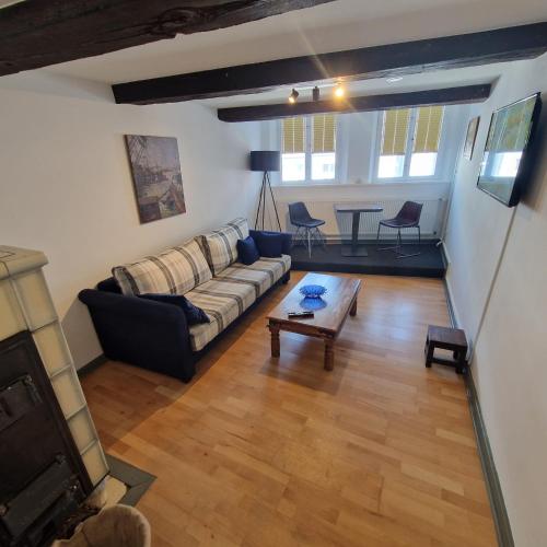 a living room with a couch and a table at Apartments im Einhornhaus in Lübeck