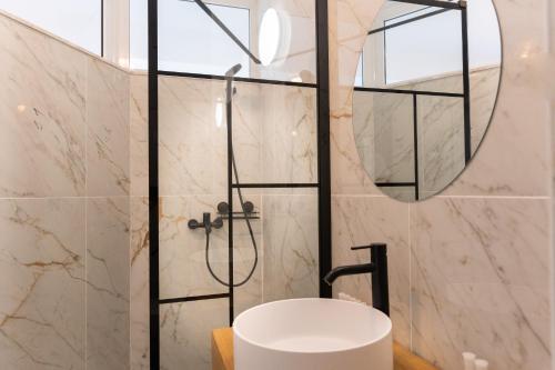 a bathroom with a shower and a white sink at Milena in Mamaia Sat/Năvodari