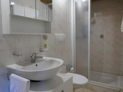 a white bathroom with a sink and a shower at Holiday Home Rustico Cleo by Interhome in Semione