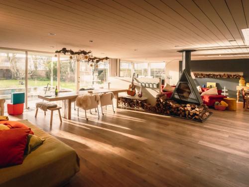 a living room with a fireplace and a table and chairs at Villa Domicile adoré by Interhome in Ostend