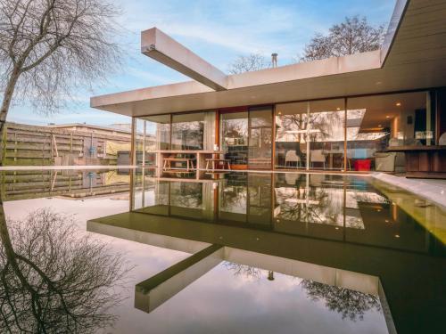 a house with a reflecting pool in front of it at Villa Domicile adoré by Interhome in Ostend