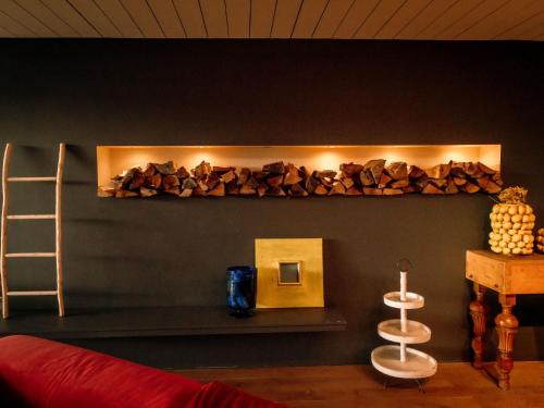 a room with a shelf with a pile of fire wood at Villa Domicile adoré by Interhome in Ostend