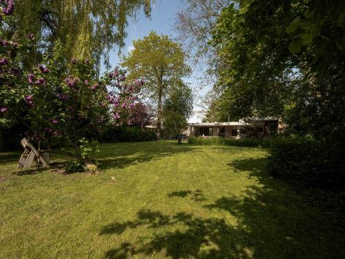 a yard with a house and trees and grass at Villa Domicile adoré by Interhome in Ostend