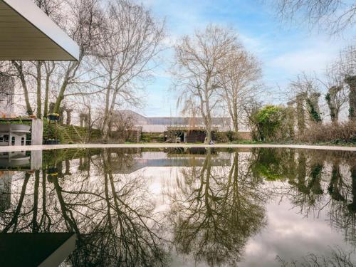 a body of water with trees and a building at Villa Domicile adoré by Interhome in Ostend