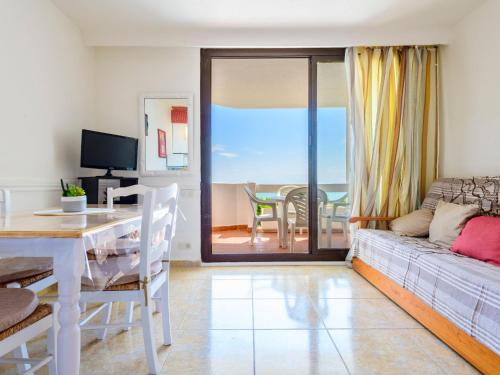 a living room with a couch and a table at Studio Eurhostal - Seaview by Interhome in Alcossebre