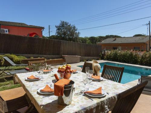 a table set for a meal next to a pool at Holiday Home Ca La Lou by Interhome in Sils