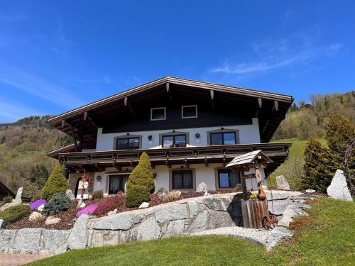 a house on top of a hill with a rock at Apartment Hüttaler by Interhome in Dorf