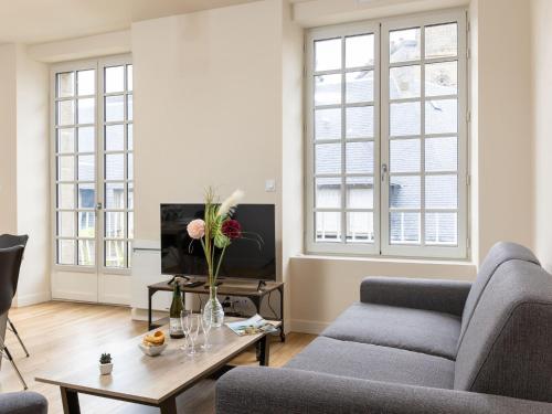 a living room with two couches and a coffee table at Apartment Plasenn by Interhome in Saint Malo