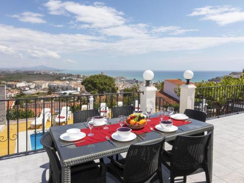 a table on a balcony with a view of the ocean at Holiday Home Villa Cuba by Interhome in Peñíscola