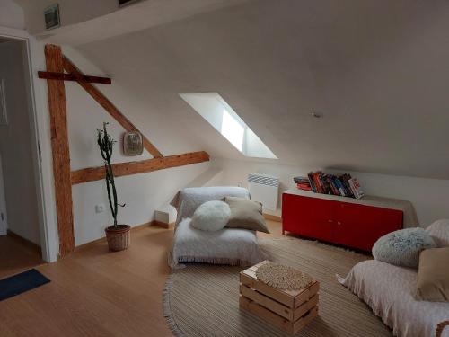 a attic living room with a couch and a table at Apartmán Mourek in Hartmanice