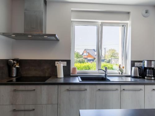 a kitchen with a sink and a window at Holiday Home Maison du Venec by Interhome in Santec