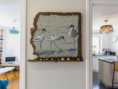 a painting of birds on a wall in a kitchen at Holiday Home Maison du Venec by Interhome in Santec