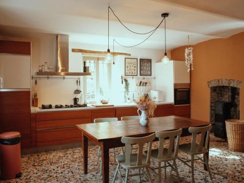 a kitchen with a wooden table and some chairs at Holiday Home Niosa by Interhome in Dego