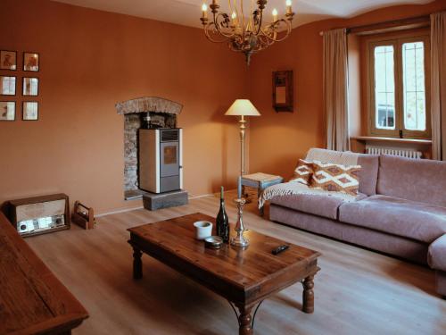 a living room with a couch and a fireplace at Holiday Home Niosa by Interhome in Dego