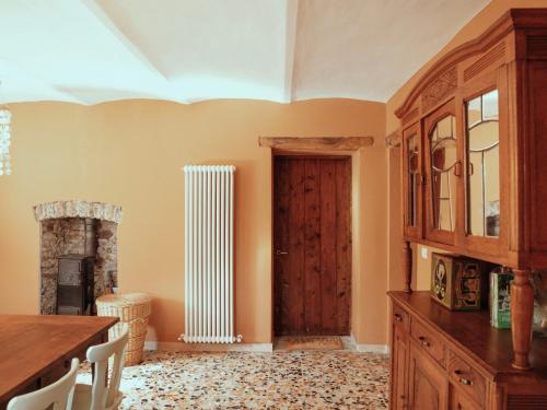 a room with a wooden door and a fireplace at Holiday Home Niosa by Interhome in Dego