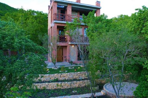 a brick house with a staircase in front of it at Villa Vejini in Mamkoda