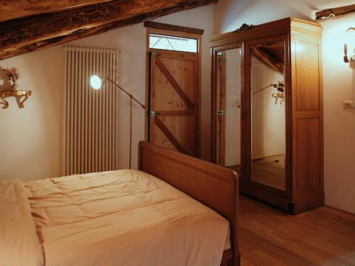 a bedroom with a bed and a window and a door at Holiday Home Niosa by Interhome in Dego