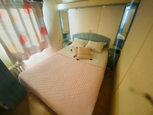 a small bed in a small room with a window at Monte do Bidé Private Farm Peace and Nature in Setúbal