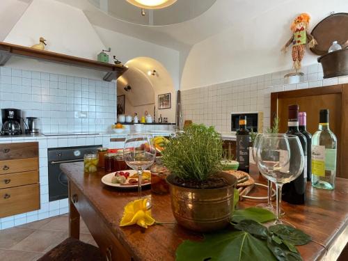 a kitchen with a table with two wine glasses at Holiday Home Casa Sylvie by Interhome in Lucinasco