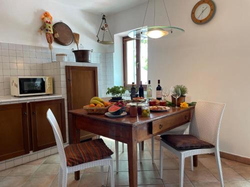 a kitchen with a wooden table with fruit on it at Holiday Home Casa Sylvie by Interhome in Lucinasco