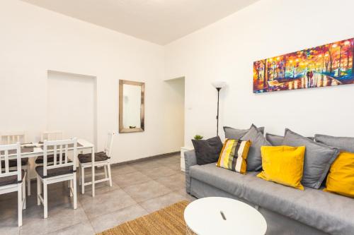 a living room with a couch and a table at Lovley Apartment close to the beach and Carmel market in Tel Aviv