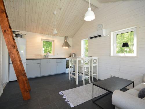 a kitchen and living room in a tiny house at Apartment Åmot höjden - HAL030 by Interhome in Mellbystrand