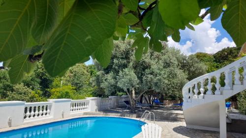 a swimming pool in a yard with a white fence at Villa Dedin in Utjeha