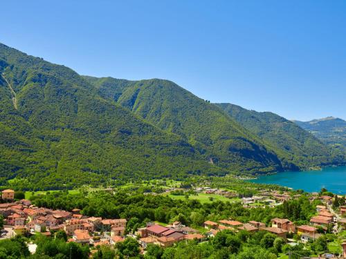 a small town in front of mountains and a lake at Apartment Stazione by Interhome in Porlezza
