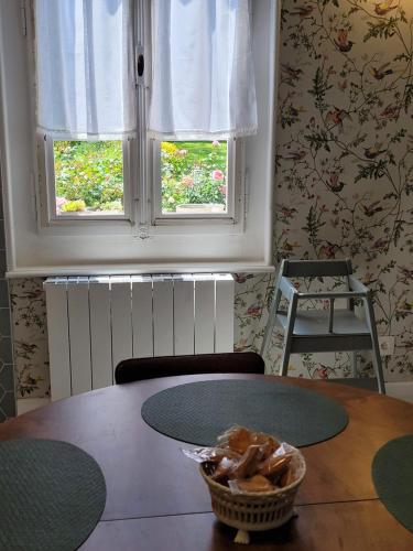 a dining room table with a basket of food on it at Les Colibris - Standing et Jardin - 3 étoiles in Cluses