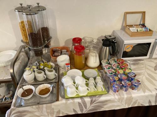 a table with a bunch of food and a blender at Szabolcs Vezér Panzió in Szabolcs