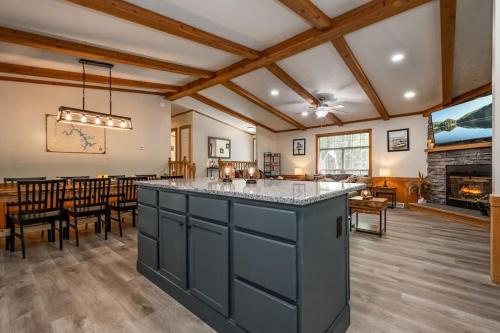 a kitchen with a large island in a room with a fireplace at *Entire House • Sleeps 9 • Hot tub • Pets Welcome* in McHenry