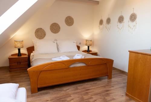 a bedroom with a large bed with two lamps at Turkus Holiday in Pobierowo