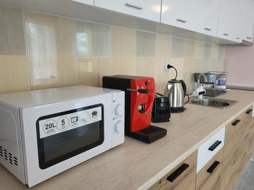 - un comptoir de cuisine avec un four micro-ondes et un évier dans l'établissement Lucky Sun Kranevo Apartments, à Kranevo