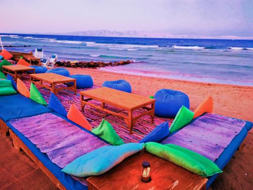 a group of tables and chairs on the beach at Ghazala Boutique Hotel Dahab in Dahab