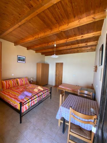 a living room with a bed and a table at Gavdos Panorama in Gavdos