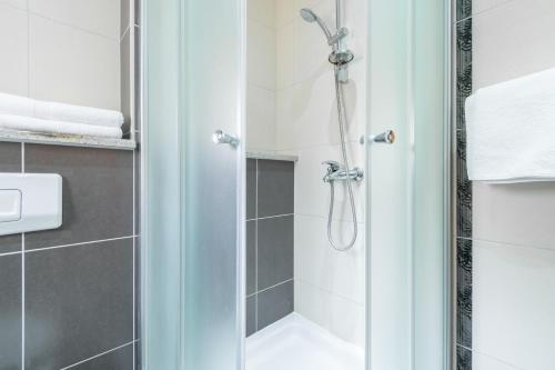 a shower with a glass door in a bathroom at Apartmani Roko in Baška Voda