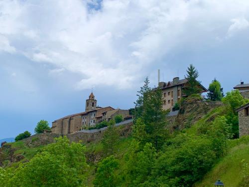 a castle on top of a hill with trees at CAL JAN - La Muralla in Bellver de Cerdanya 