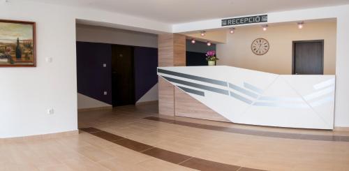 a lobby with a reception desk in a building at Hotel Pallone in Balatonfüred